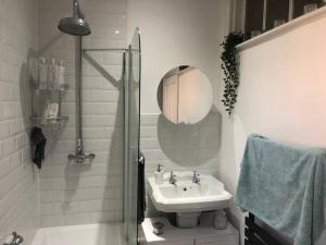 a white bathroom with a sink and a mirror at Victorian Town House in the Heart of Dover in Dover