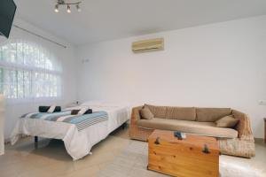 a living room with a bed and a couch at Estudio Casa Marie in Estepona +15 photos