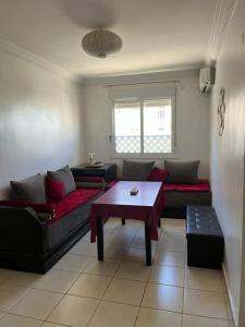 a living room with two couches and a table at Charmant appart à 15 minutes de la plage et du centre ville M'DICQ, TETOUAN in M'diq