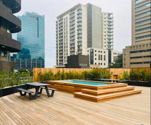 a patio with a table and a pool in a city at Executive City Micro Living in Long Street at One Thibault in Cape Town