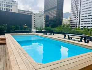 a large blue swimming pool on top of a building at Executive City Micro Living in Long Street at One Thibault in Cape Town