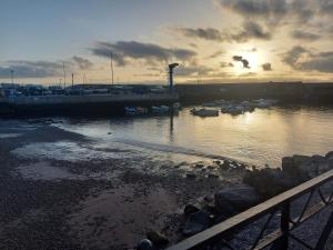 a sunset over a harbor with boats in the water at ESTUDIO LA ESTRELLA in Candelaria