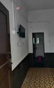 a room with a door and a television on the wall at SPOT ON Hotel New Bright in Garhmuktesar