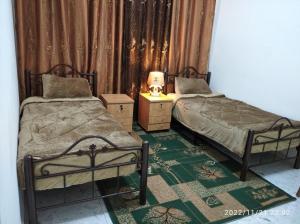 two beds sitting next to each other in a room at بيت ضيافة حنضلة in Bethlehem