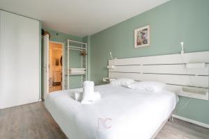 een slaapkamer met een groot wit bed in een kamer bij *Disneyland-Paris* 4pers Wifi, Parking, Netflix in Serris