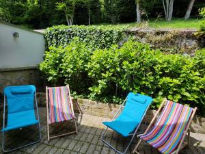 a group of three chairs sitting on a patio at Maison face à l'abbaye d'Hautvillers - 2 bedrooms 2 Bathrooms, parking in Hautvillers +20 photos