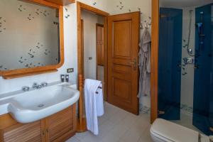 a bathroom with a sink and a shower and a toilet at Palazzo Moresco in Santa Marinella