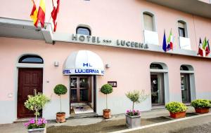a pink building with a hotel at Hotel Lucerna in Castiglione della Pescaia