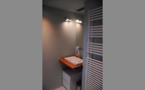 a small bathroom with a toilet and a sink at Gite des Bois de Spa in Spa