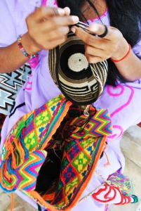 a woman is tying a tie on a scarf at Hotel Majayura Sol in Ríohacha