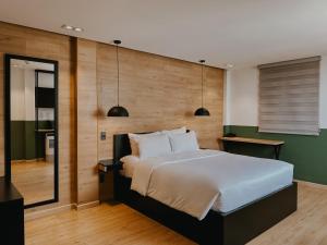 a bedroom with a large bed and a green wall at Chotel Pham Ngu Lao in Ho Chi Minh City +17 photos