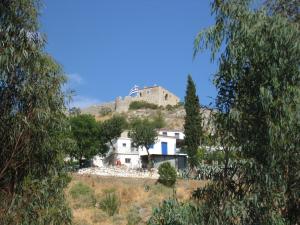 a house on a hill with a castle on top at Castle View Studios in Paralio Astros