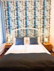 a bedroom with a large bed with blue pillows at Hotel Nord in Hamburg