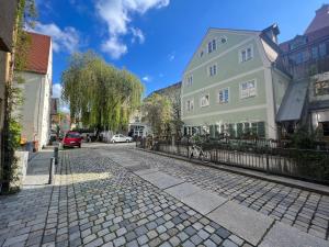 a cobblestone street in a town with buildings at LIBORIA III Wohnen im Denkmal Augsburgs in Augsburg