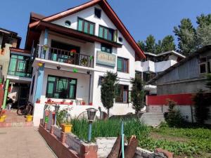 a white house with a sign on it at Foreshore Resort in Srinagar