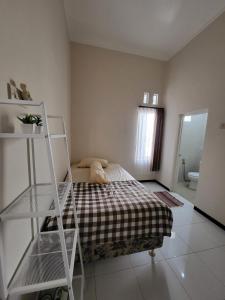 a bedroom with a bed and a ladder in it at SAMARA VILLA in Batu