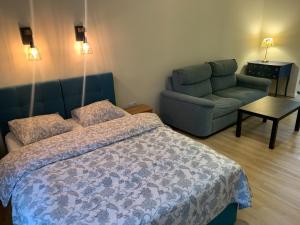 Łóżko lub łóżka w pokoju w obiekcie Apartamenty i Studia HERBARIUM