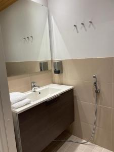 a bathroom with a sink and a mirror at Spa Hotel RED in Tahkovuori