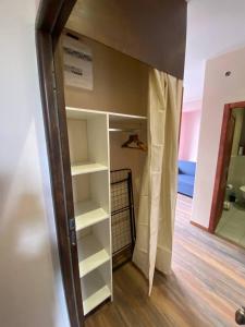 a closet with shelves in a room at Appartements touristique - La Colombière in Lourdes