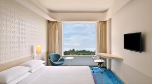 a hotel room with a bed and a window at Fairfield by Marriott Hyderabad Gachibowli in Hyderabad