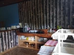 a room with a kitchen with a table and a microwave at Elje Villa in La Digue