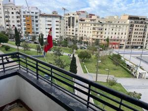 a view of a city from a balcony with a flag at إقامة 16 ساحة الامم in Tangier
