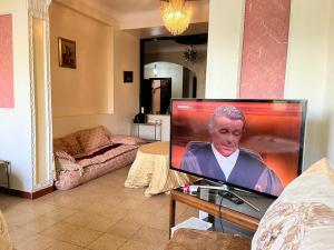 a flat screen tv sitting in a living room at إقامة 16 ساحة الامم in Tangier