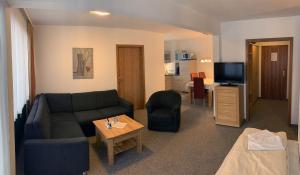 a living room with a couch and a table at Chiemgau Appartements in Inzell