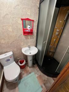 a bathroom with a toilet and a sink and a shower at Lovely home in Osh