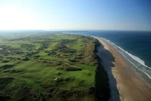 an aerial view of a golf course and the ocean at Portrush Getaway - Holiday Let in Portrush