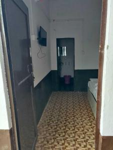 a room with a room with a bed and a door at SPOT ON Hotel New Bright in Garhmuktesar