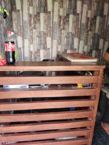 a wooden dresser with a soda bottle on top of it at SPOT ON Hotel New Bright in Garhmuktesar