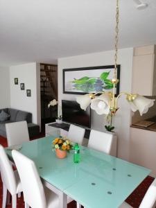 a dining room with a green table and white chairs at Hotel Residence in Grindelwald