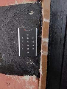 a remote control on a door on a wall at Basung Homestay Sinsuran in Kota Kinabalu