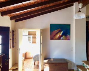 a living room with a painting on the wall at Casa Anneli - relaxing under the olive tree in Aljezur