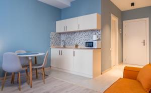 una pequeña cocina con mesa y microondas en New Gudauri GoodHost Apartments, en Gudauri