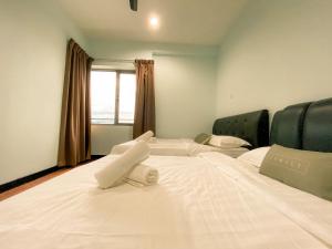 a hotel room with two beds and a window at Maison life 小居屋 The Loft Imago in Kota Kinabalu