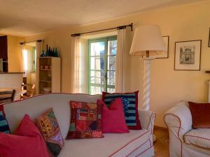 a living room with a couch with colorful pillows at Antico Borgo di Sugame in Greve in Chianti