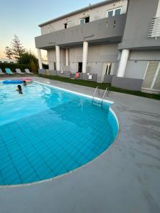 a large swimming pool in front of a building at Banana Moon in Adelianos Kampos