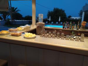 a buffet at a resort with food on a counter at Banana Moon in Adelianos Kampos