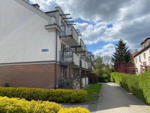 a building with balconies on the side of a street at Apartament Wrocławska in Olsztyn