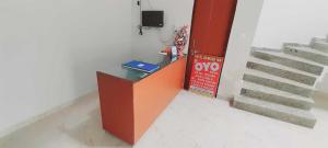 a room with stairs and a desk with a tv at SPOT ON Hotel Daimond Inn in Meerut