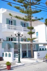 a building with a street light in front of it at Lefkothea Hotel in Kamari