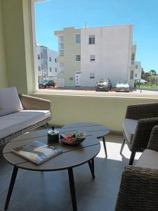 a room with a table and chairs and a large window at DREAMS APARTMENT KAŠTELA in Kaštela