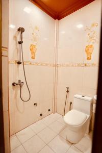 a bathroom with a shower and a toilet at Captal Island Villa in Mathiveri