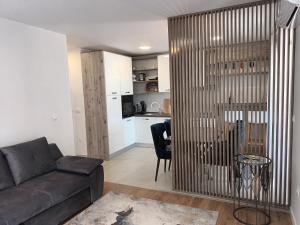 a living room with a couch and a table at DREAMS APARTMENT KAŠTELA in Kaštela