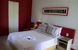 A bed or beds in a room at Pousada da Serra da Luz