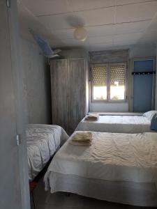 a bedroom with two beds and a window at Can ventura in Deltebre