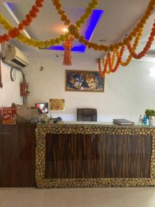 a kitchen with a counter with a bar with orange decorations at OYO BNB Manju Home Stay Near Dwarka Sector 11 Metro Station in New Delhi