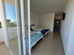 En eller flere senger på et rom på Mare S&M Casa Hostal